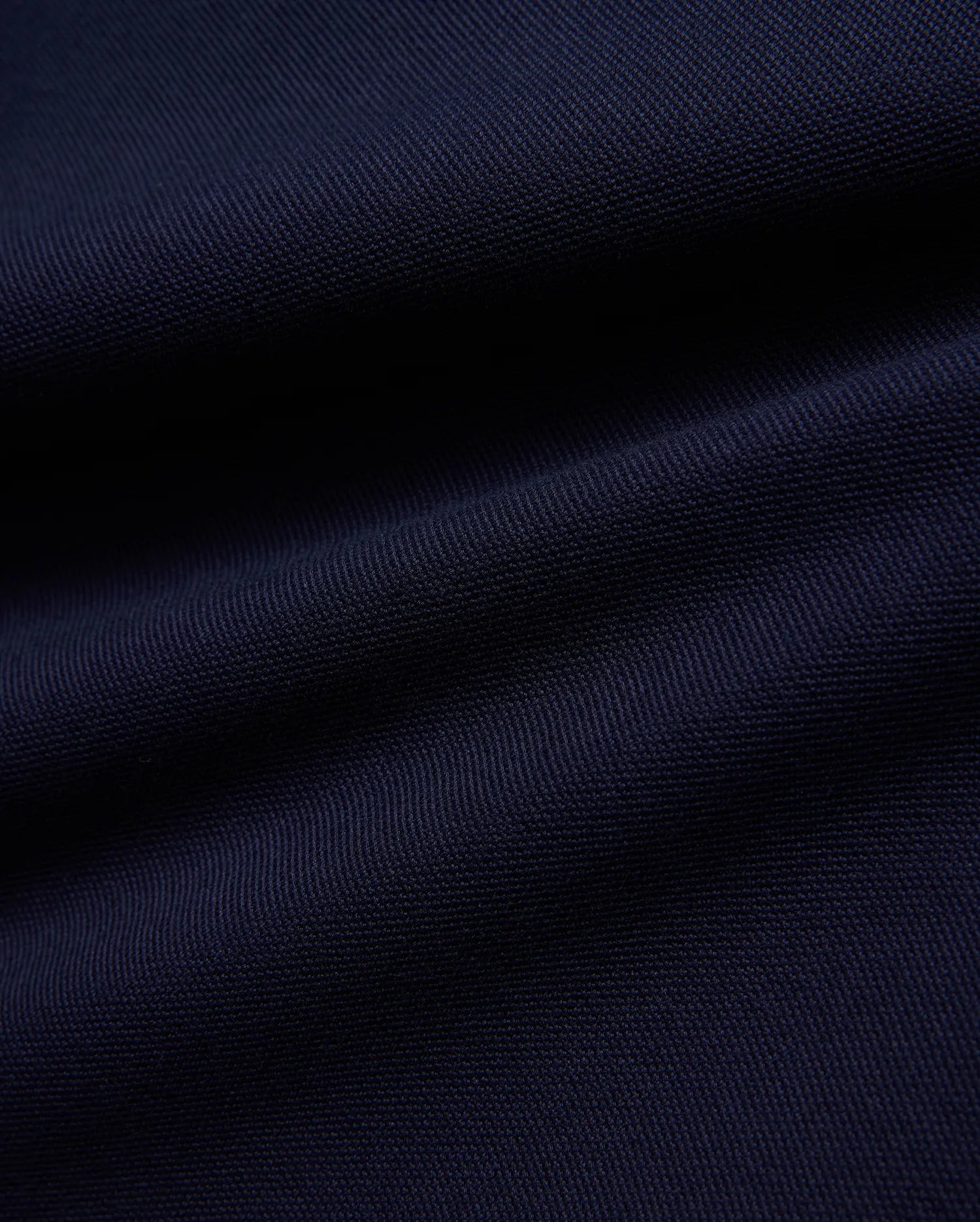 KIDS JAYDON PIQUE POLO in a deep, luxurious navy blue, showcasing the intricate, breathable texture of its premium pique knit fabric, a hallmark of Psycho Bunny's refined quality.