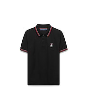 Kids Jaydon Pique Polo, black classic fit pique polo with red and white striped collar and cuffs, featuring a small embroidered Psycho Bunny skull logo on the left chest.