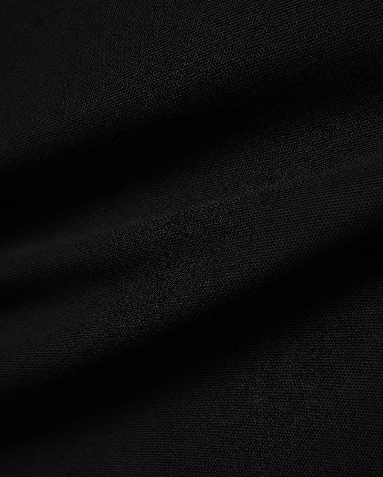 Kids Jaydon Pique Polo in deep black, showcasing its premium textured pique fabric, designed for a classic fit, and featuring the signature small embroidered Psycho Bunny skull logo on the left chest.