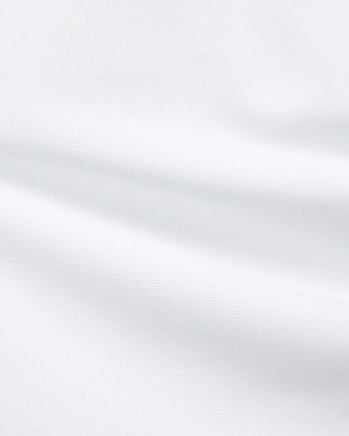 Premium White Kids Jaydon Pique Polo fabric, a detailed close-up revealing the refined, textured pique weave and elegant, subtle folds, reflecting the brand's quality.