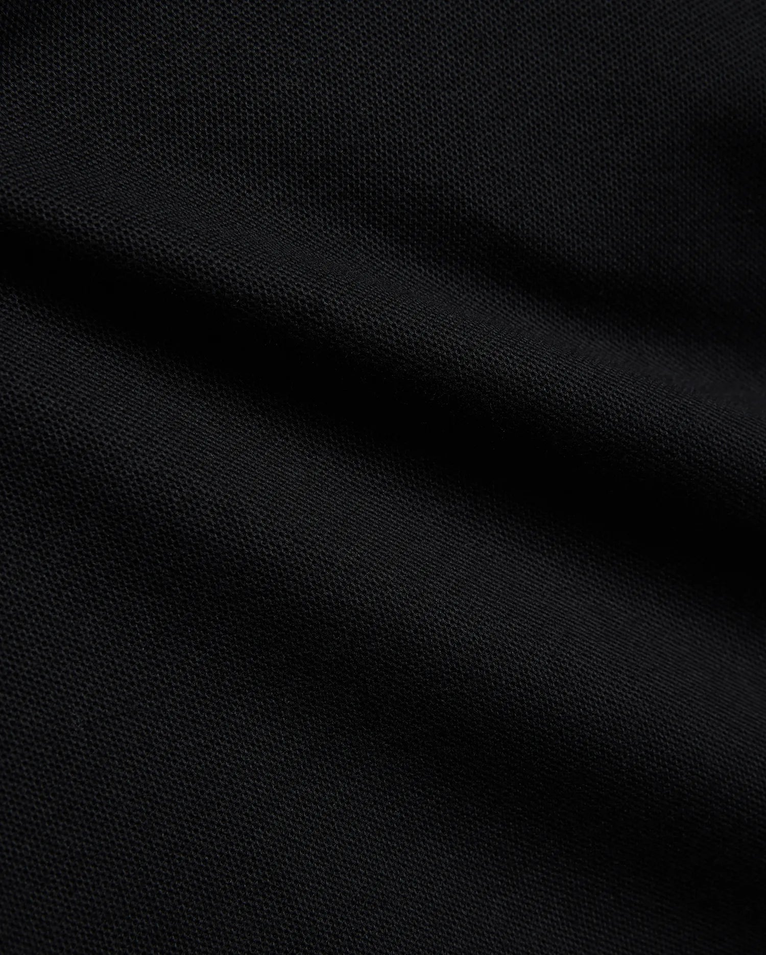 Psycho Bunny Kids Stan Pique Polo in deep black, showcasing the premium, breathable pique knit fabric with a subtle texture, perfect for refined streetwear. (6)