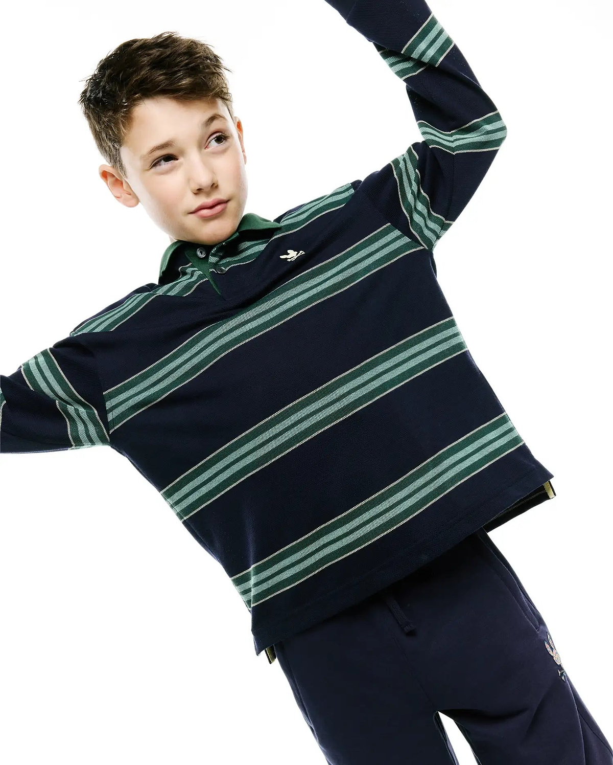 Kids Drew Striped L/S Pique Polo in classic fit navy blue pique, featuring long sleeves, a green collar, two-button placket, horizontal green and white stripes, and a small embroidered Psycho Bunny skull logo on the left chest.