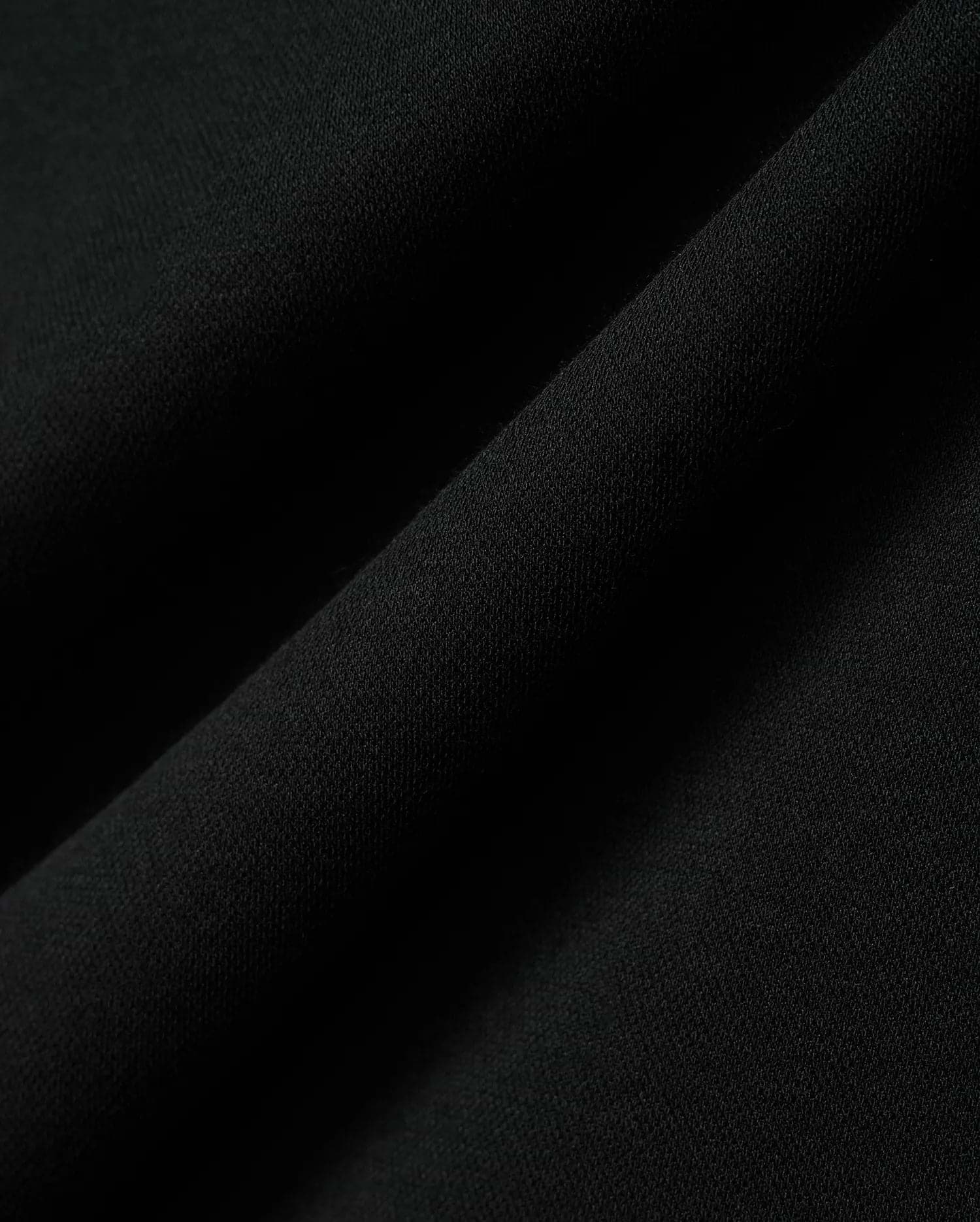 Kids Timmy Pique Polo in classic black, featuring a premium, finely textured pique knit fabric with soft, flowing folds, embodying Psycho Bunny's signature style. (6)