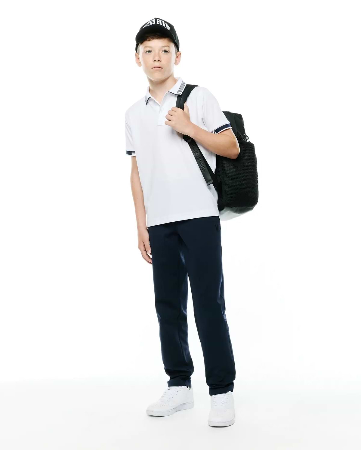 Kids Timmy Pique Polo, white with navy blue striped collar and cuffs, classic fit, pique fabric, featuring a small embroidered Psycho Bunny skull logo on the left chest.