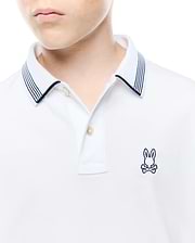 Kids Timmy Pique Polo, a classic white pique polo featuring a two-button placket, navy blue striped collar, and a small embroidered Psycho Bunny skull logo on the left chest.