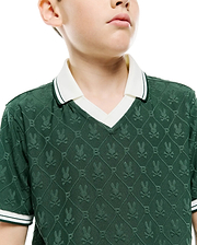 Kids Garry Jacquard Johnny Collar Polo in dark green, featuring an all-over textured Psycho Bunny skull logo pattern, white Johnny collar, and striped sleeve cuffs. Classic fit.