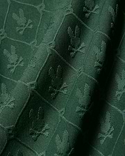 Kids Garry Jacquard Johnny Collar Polo in deep green, featuring an all-over tonal jacquard knit pattern of the iconic Psycho Bunny skull logo within a subtle geometric grid.
