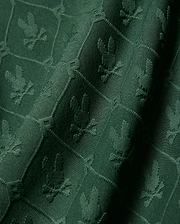 Kids Garry Jacquard Johnny Collar Polo in deep green, featuring an all-over tonal jacquard knit pattern of the iconic Psycho Bunny skull logo within a subtle geometric grid.