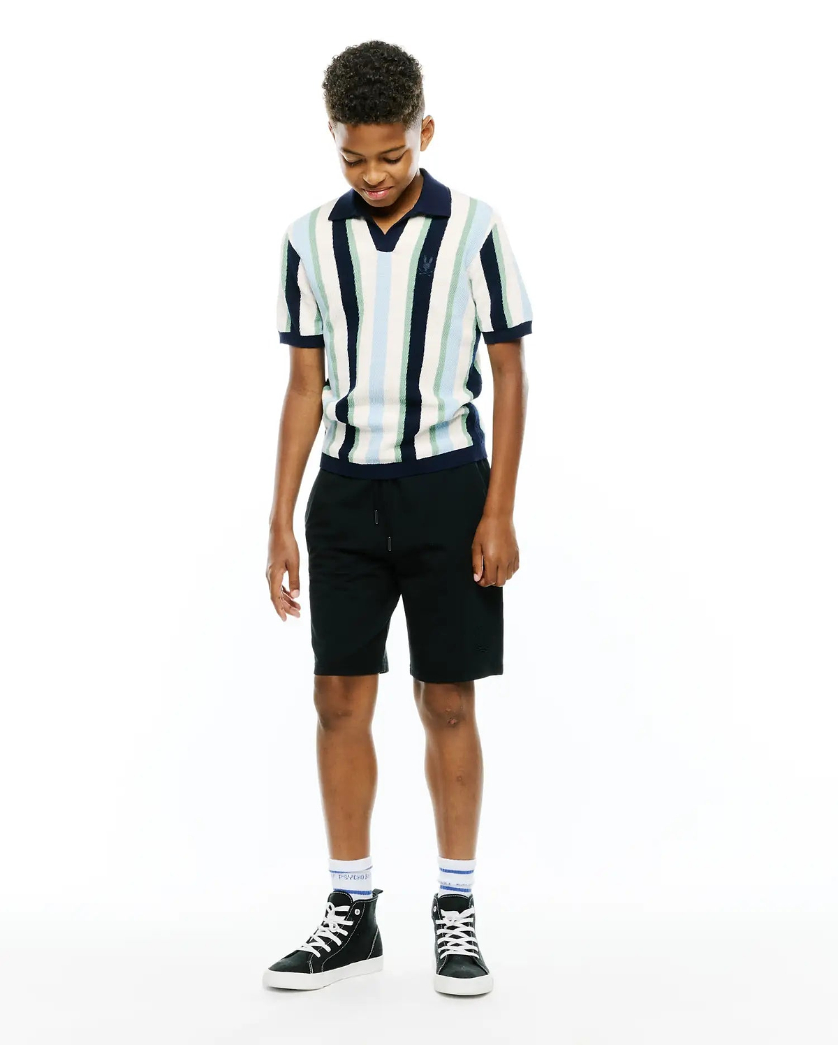 Kids Wren Stripe Knit Polo, a classic fit knit polo with vertical stripes in white, light blue, mint, and navy, featuring a navy collar and cuffs, and a small embroidered Psycho Bunny skull logo on the left chest.