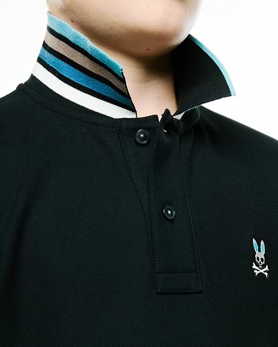 Kids' Klaus Pique Polo: dark green classic pique knit, two-button placket, striped ribbed collar (white, black, brown, blue), small embroidered blue-eared Psycho Bunny skull on right chest. (2)