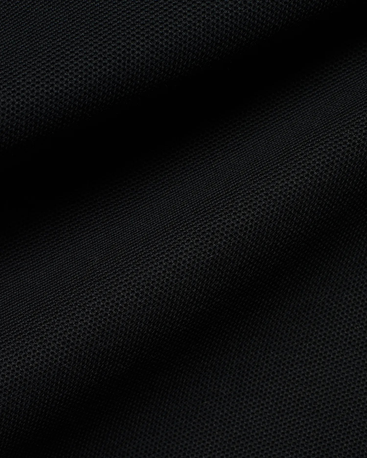 Kids' Klaus Pique Polo in classic black, showcasing the refined, breathable pique fabric texture, characteristic of premium Psycho Bunny streetwear, designed for comfort and style. (6)