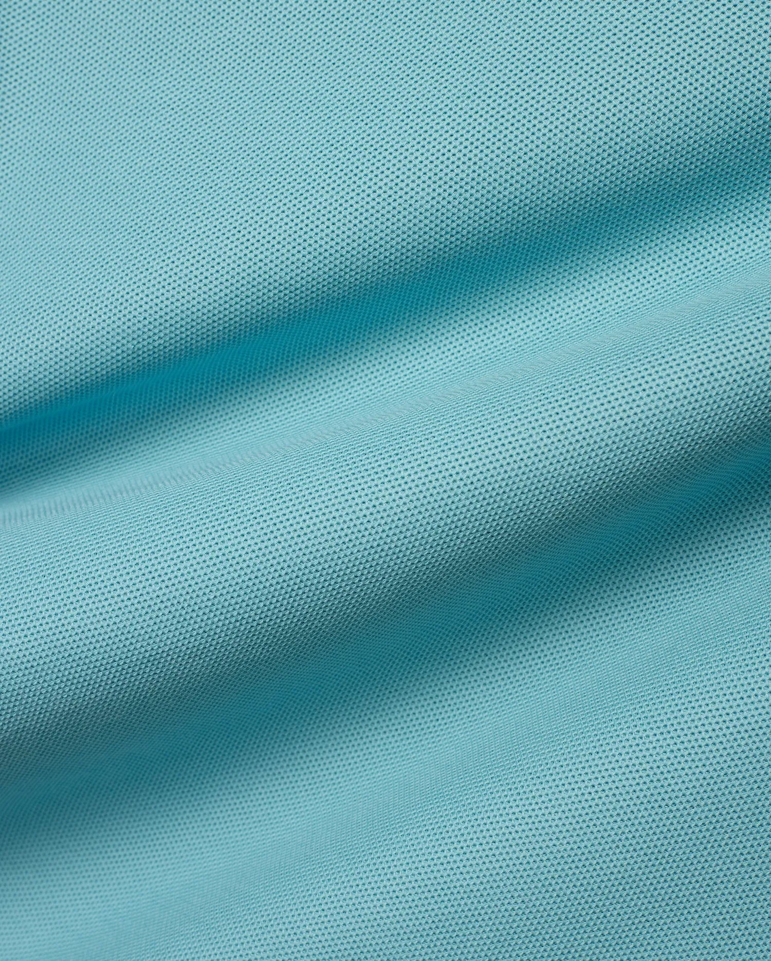 Kids' Klaus Pique Polo fabric in a vibrant aqua hue, featuring its signature textured pique weave with gentle ripples, reflecting premium Psycho Bunny quality. (6)