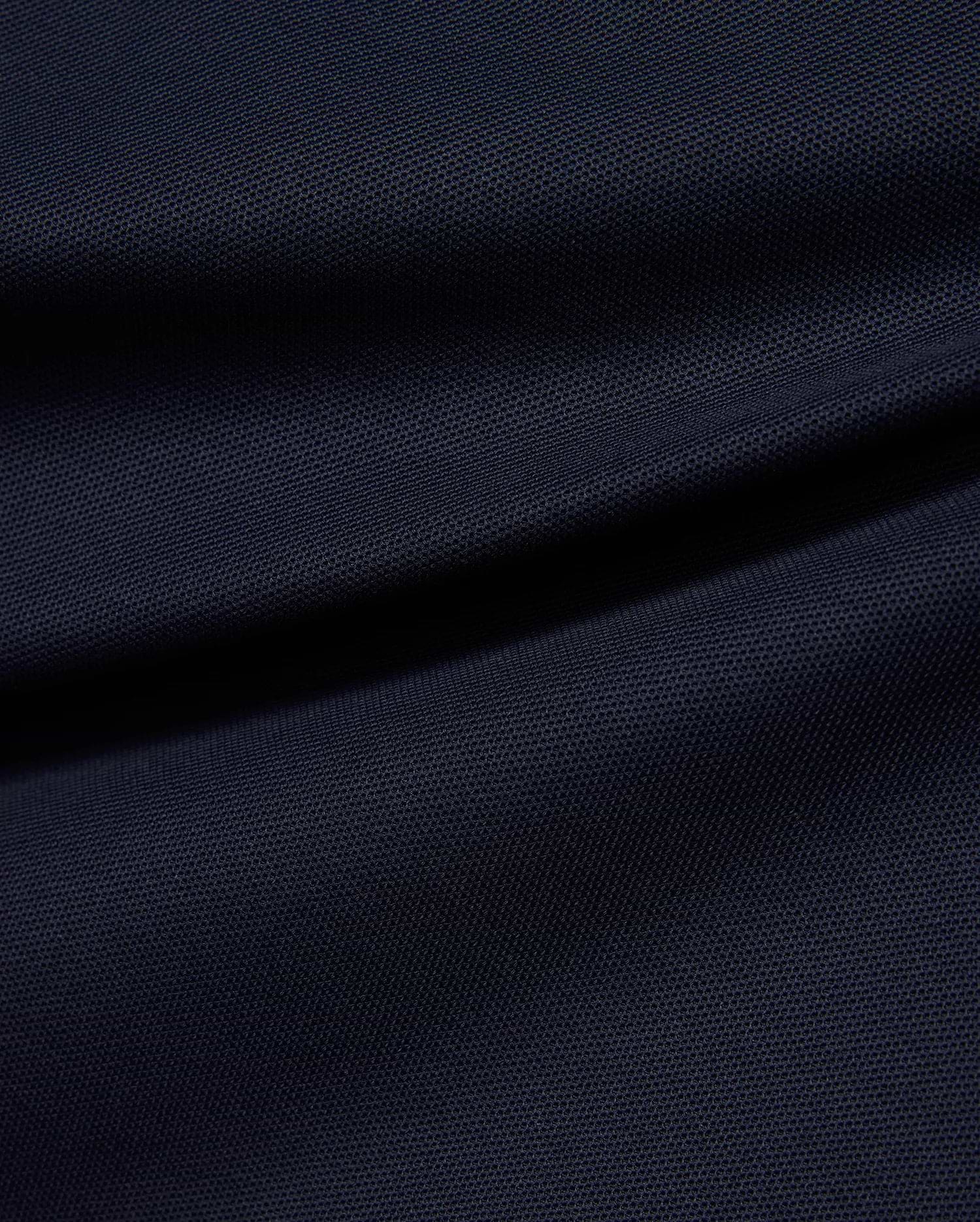 Kids' Grover Pique Longsleeve Polo in deep navy blue, showcasing the classic textured pique knit fabric with subtle draping, ideal for comfortable, stylish wear. (6)