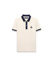 Kids Robin Pique Polo in cream pique fabric with a navy blue collar, placket, and sleeve cuffs, featuring a classic fit and an embroidered Psycho Bunny skull logo on the left chest.