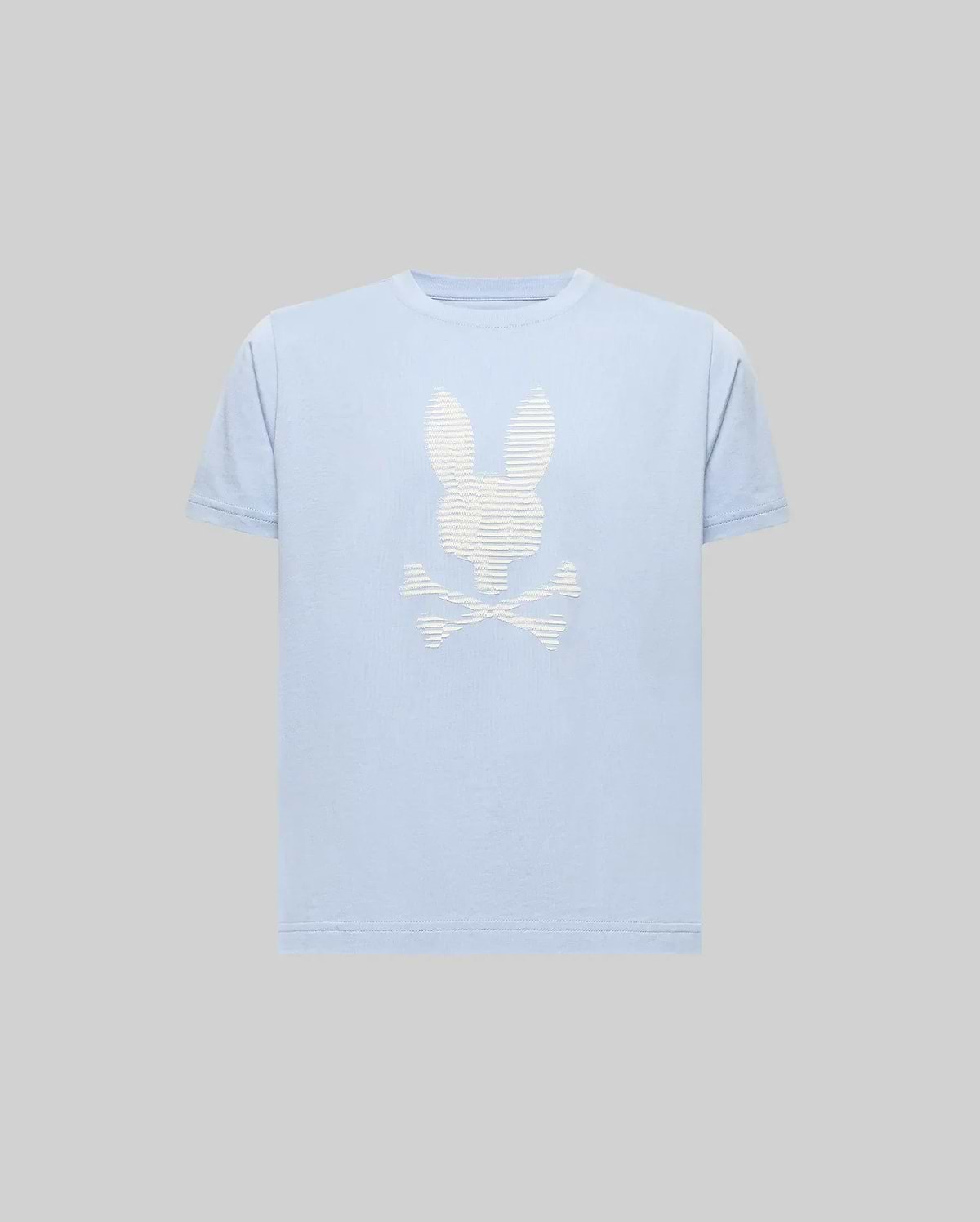 The Psycho Bunny KIDS GRANT BUNNY GRAPHIC TEE (KT0200061) is a light blue Pima cotton tee featuring an HD-printed white bunny head above crossed bones on the chest, shown on a plain gray background. (1)