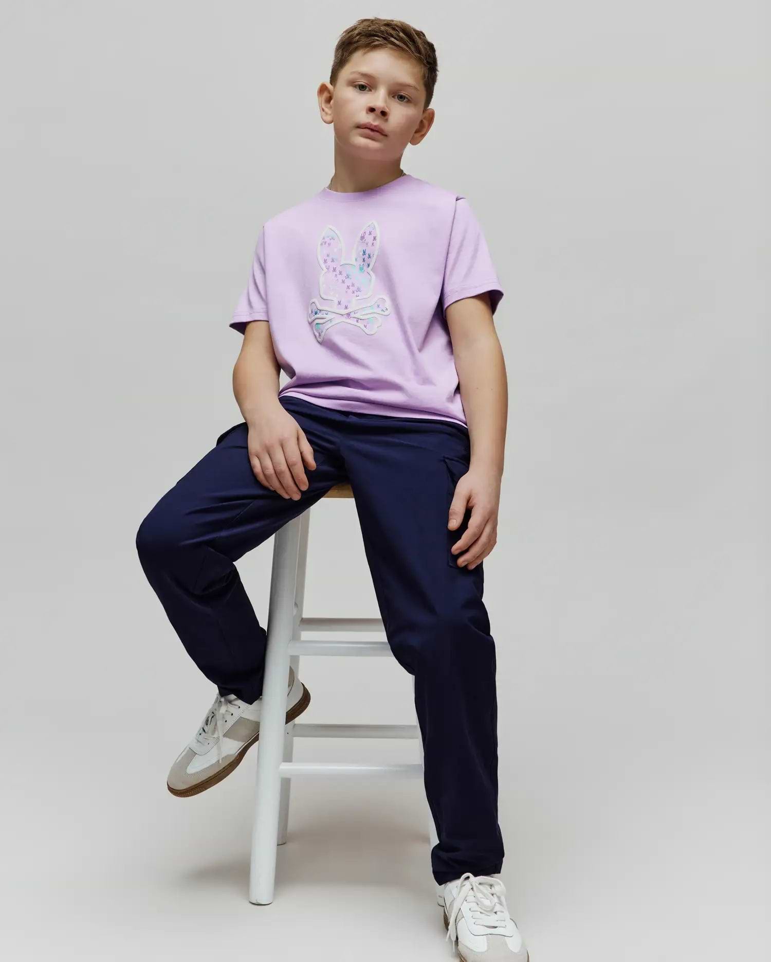 Kids Nev Bunny Graphic Tee in lilac jersey with a large iridescent patterned bunny skull logo on the chest, paired with navy relaxed fit pants. (4)