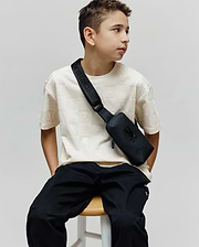 Kids Dustin Oversized Tee in cream, featuring an all-over embossed checkerboard pattern with small Psycho Bunny skull logos, offering a relaxed fit in a textured knit fabric.
