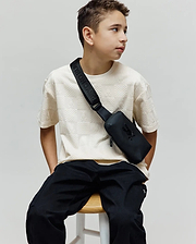 Kids Dustin Oversized Tee in cream, featuring an all-over embossed checkerboard pattern with small Psycho Bunny skull logos, offering a relaxed fit in a textured knit fabric.