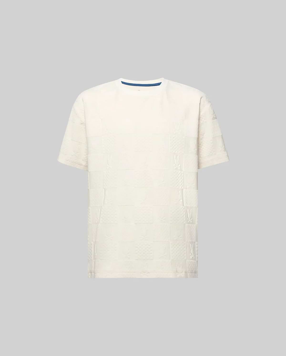 Kids Dustin Oversized Tee in cream, featuring an all-over textured checkerboard pattern with embossed Psycho Bunny skull logos and a subtle blue inner collar trim.