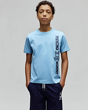 Kids Toby Wordmark Tee, light blue classic fit jersey knit t-shirt with a large vertical dark blue Psycho Bunny wordmark and skull logo graphic on the right side.