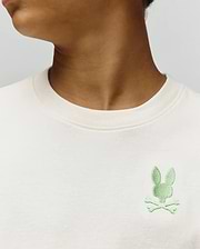 Kids Aiden Back Graphic Tee, a classic fit cream jersey t-shirt featuring a small, embroidered light green Psycho Bunny skull and crossbones logo on the left chest.