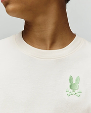 Kids Aiden Back Graphic Tee, a classic fit cream jersey t-shirt featuring a small, embroidered light green Psycho Bunny skull and crossbones logo on the left chest.