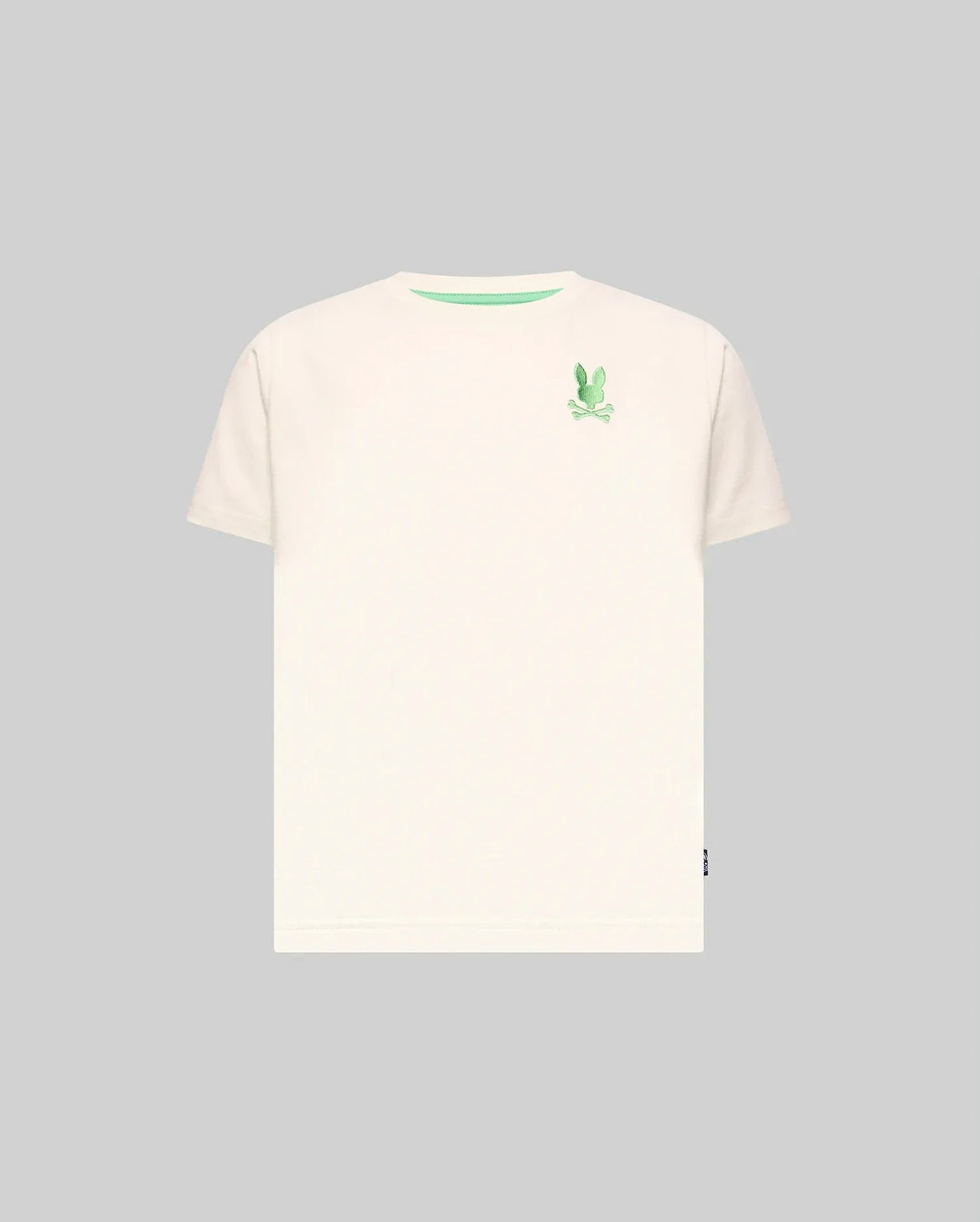 Kids Aiden Back Graphic Tee, a classic fit cream jersey t-shirt featuring a small embroidered green Psycho Bunny skull logo on the left chest and a green inner collar trim.