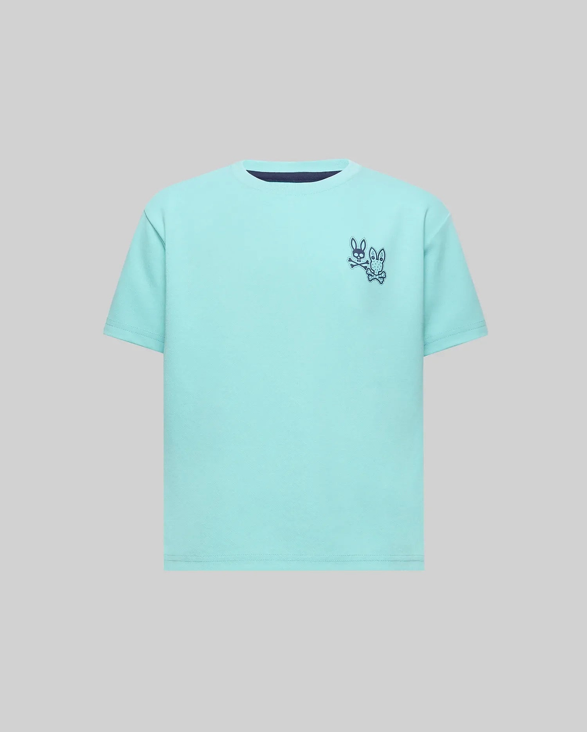 Kids Luke Back Graphic Tee, an aqua classic fit jersey with a navy crew neck trim and a small navy Psycho Bunny skull and crossbones graphic alongside another bunny on the left chest.
