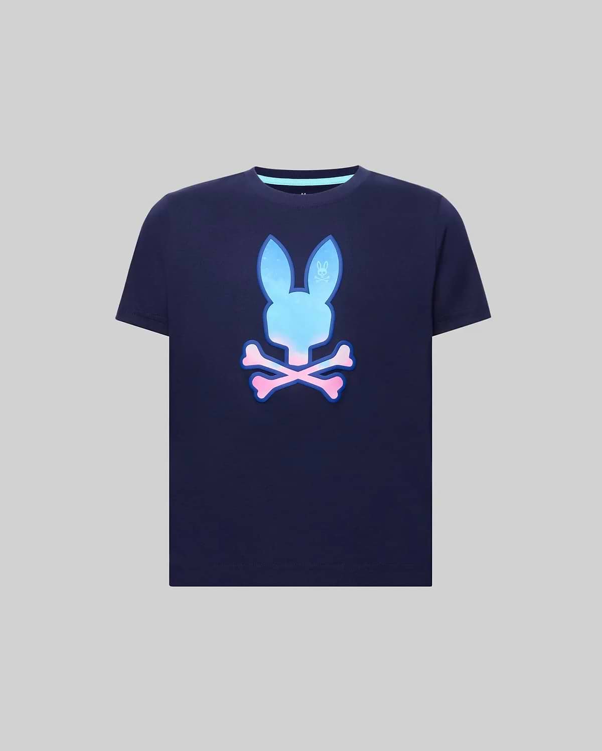 Kids Caspian Graphic Tee, navy blue classic fit jersey t-shirt featuring a large gradient blue to pink Psycho Bunny skull and crossbones graphic on the center chest, with a light blue inner collar trim.