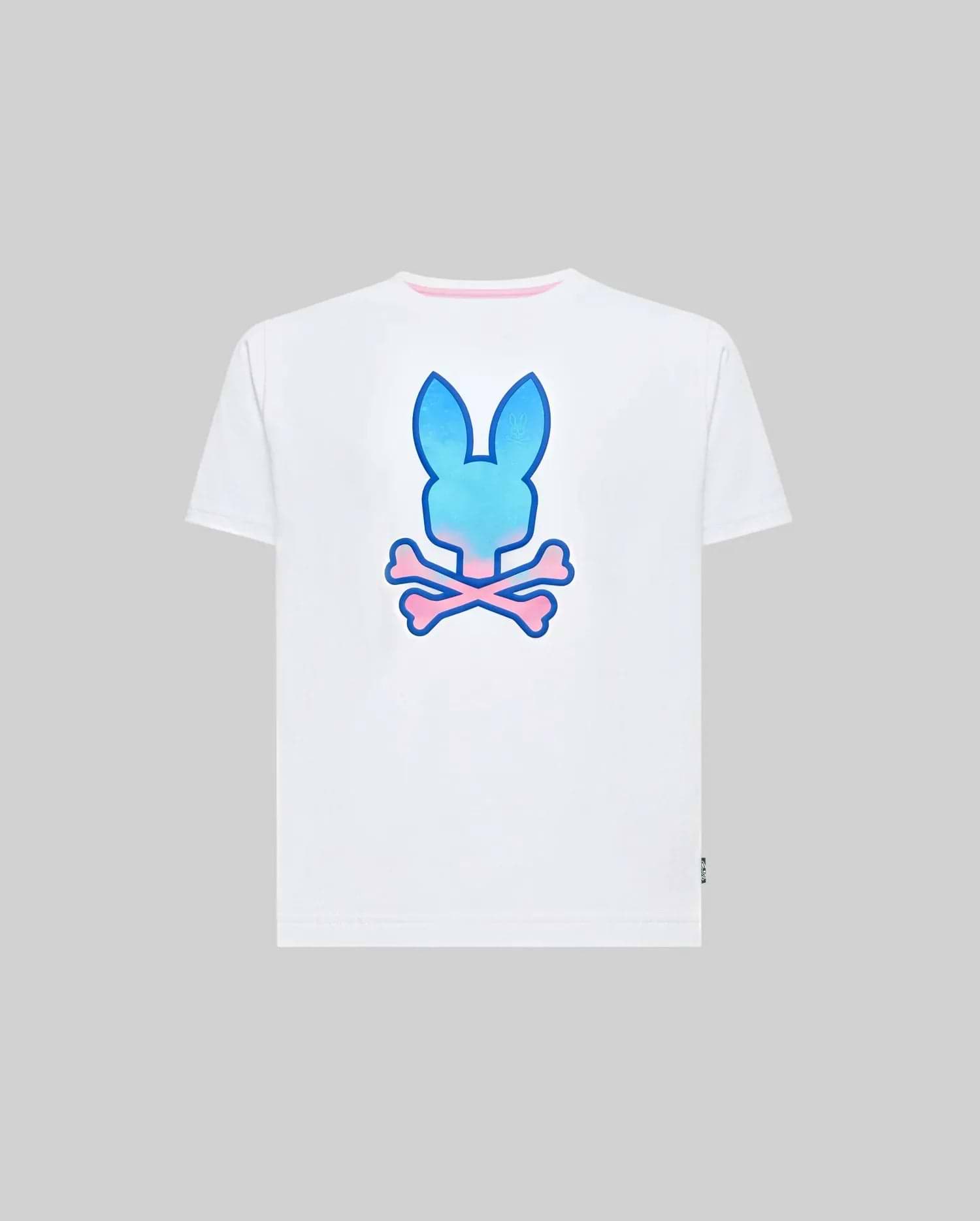 Kids Caspian Graphic Tee, white classic fit jersey t-shirt featuring a large gradient blue and pink Psycho Bunny skull logo on the back, pink inner collar trim, and a small green hem tag.