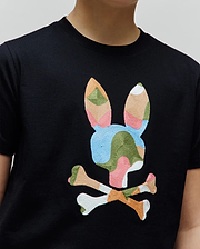 Kids Ara Graphic Tee: Black jersey t-shirt with a large, central embroidered Psycho Bunny skull logo featuring a vibrant, multi-colored abstract pattern in pink, blue, green, orange, and white.