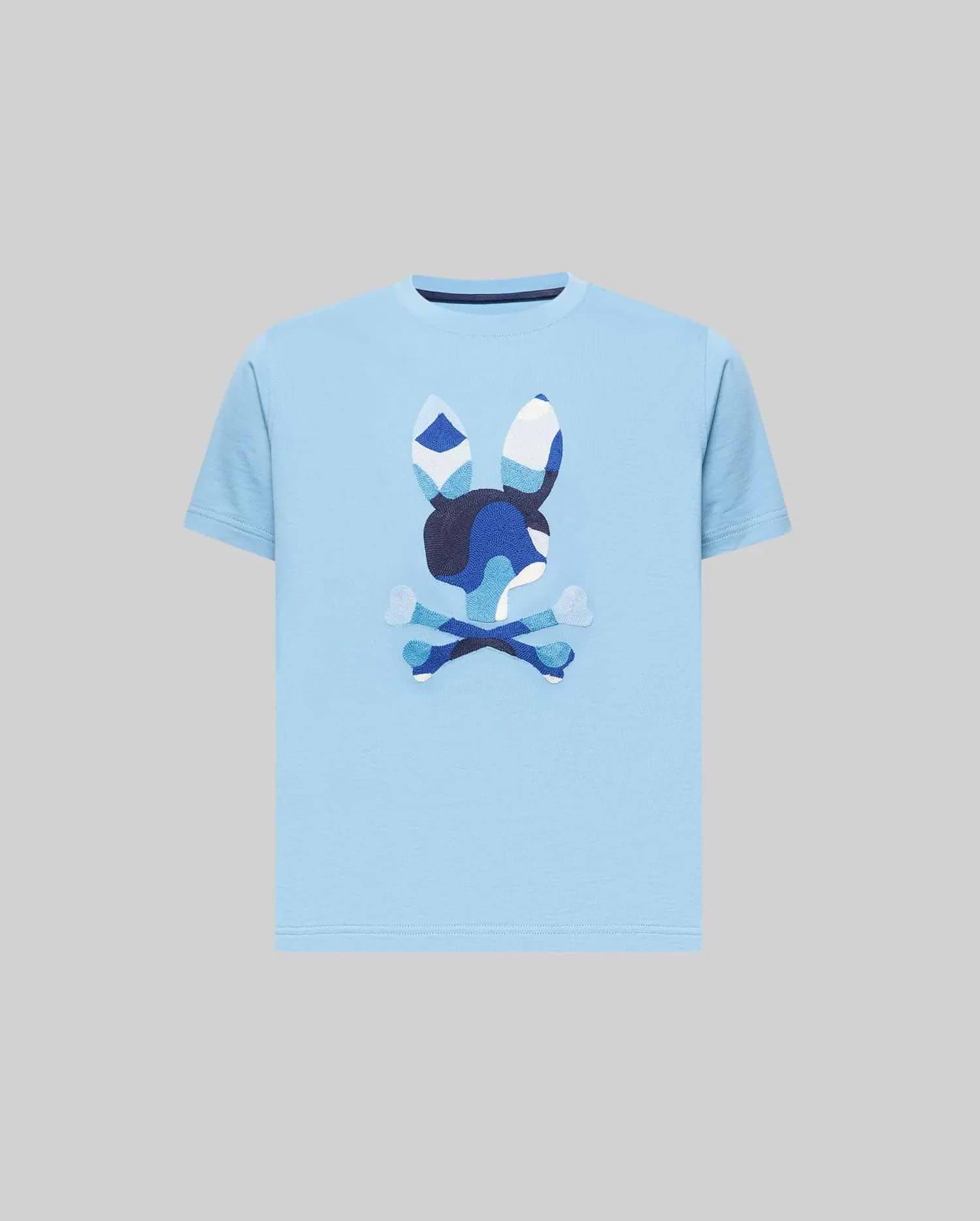 Kids Ara Graphic Tee, a classic fit sky blue jersey knit t-shirt featuring a large, center chest Psycho Bunny skull logo with a distinctive blue and white camouflage pattern.