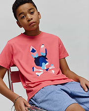 Kids Ara Graphic Tee, a classic fit coral pink jersey t-shirt featuring a large, central embroidered Psycho Bunny skull logo in shades of blue, pink, and white.