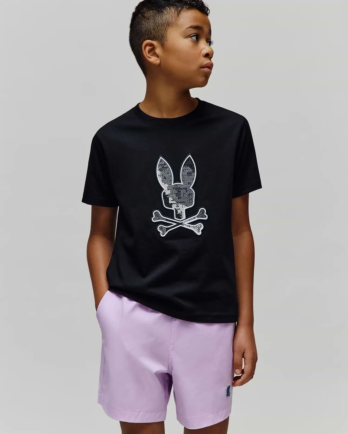 Kids Olivier Graphic Tee, black classic fit jersey t-shirt featuring a large, textured white and silver Psycho Bunny skull and crossbones graphic on the center chest. (2)