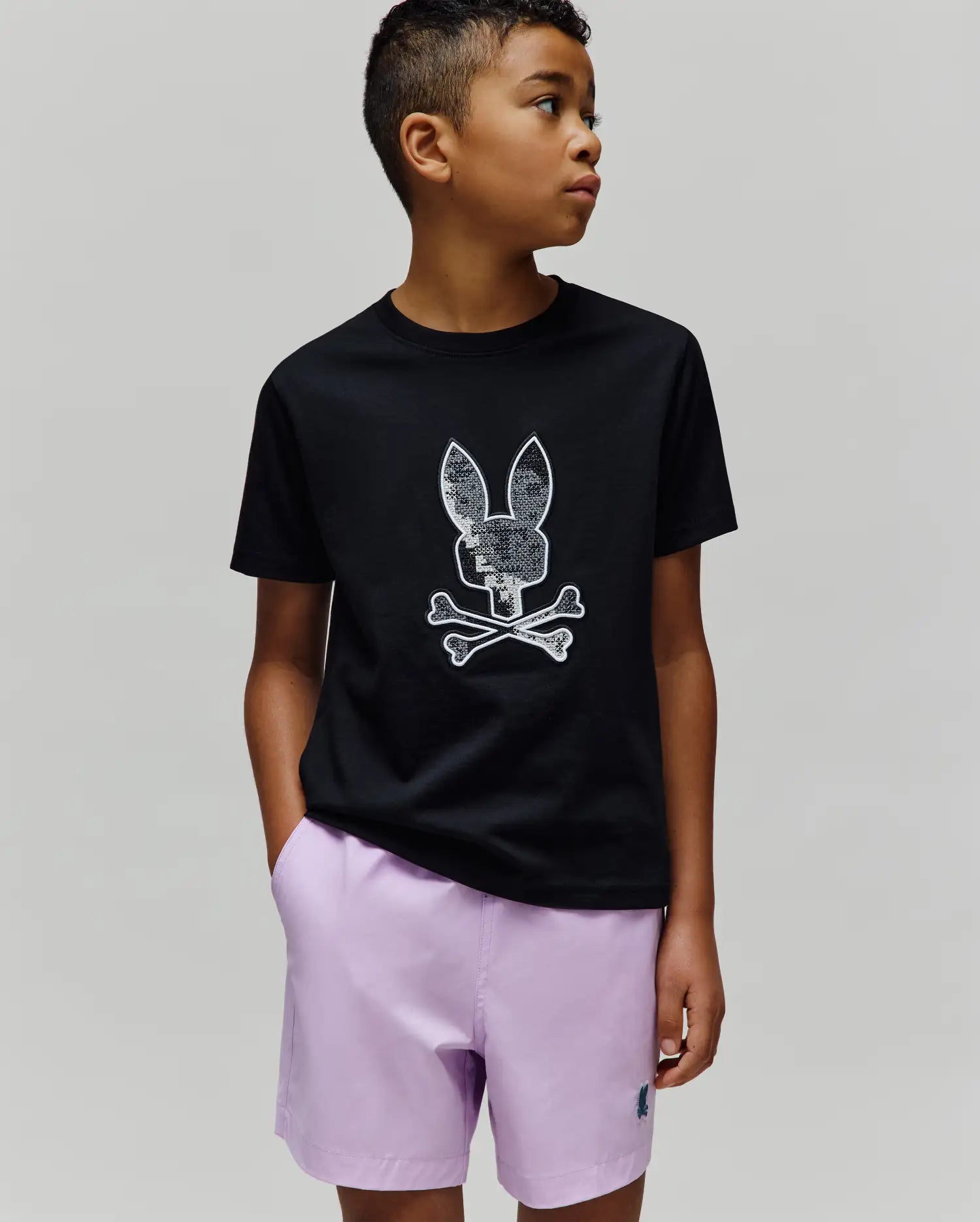 Kids Olivier Graphic Tee, black classic fit jersey t-shirt featuring a large, textured white and silver Psycho Bunny skull and crossbones graphic on the center chest. (2)