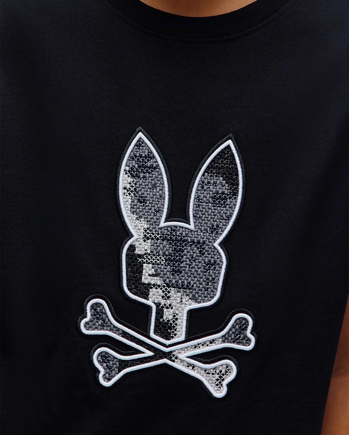 Kids Olivier Graphic Tee, black jersey knit with a large central embroidered Psycho Bunny skull logo featuring a grey pixelated pattern and white outline. (3)