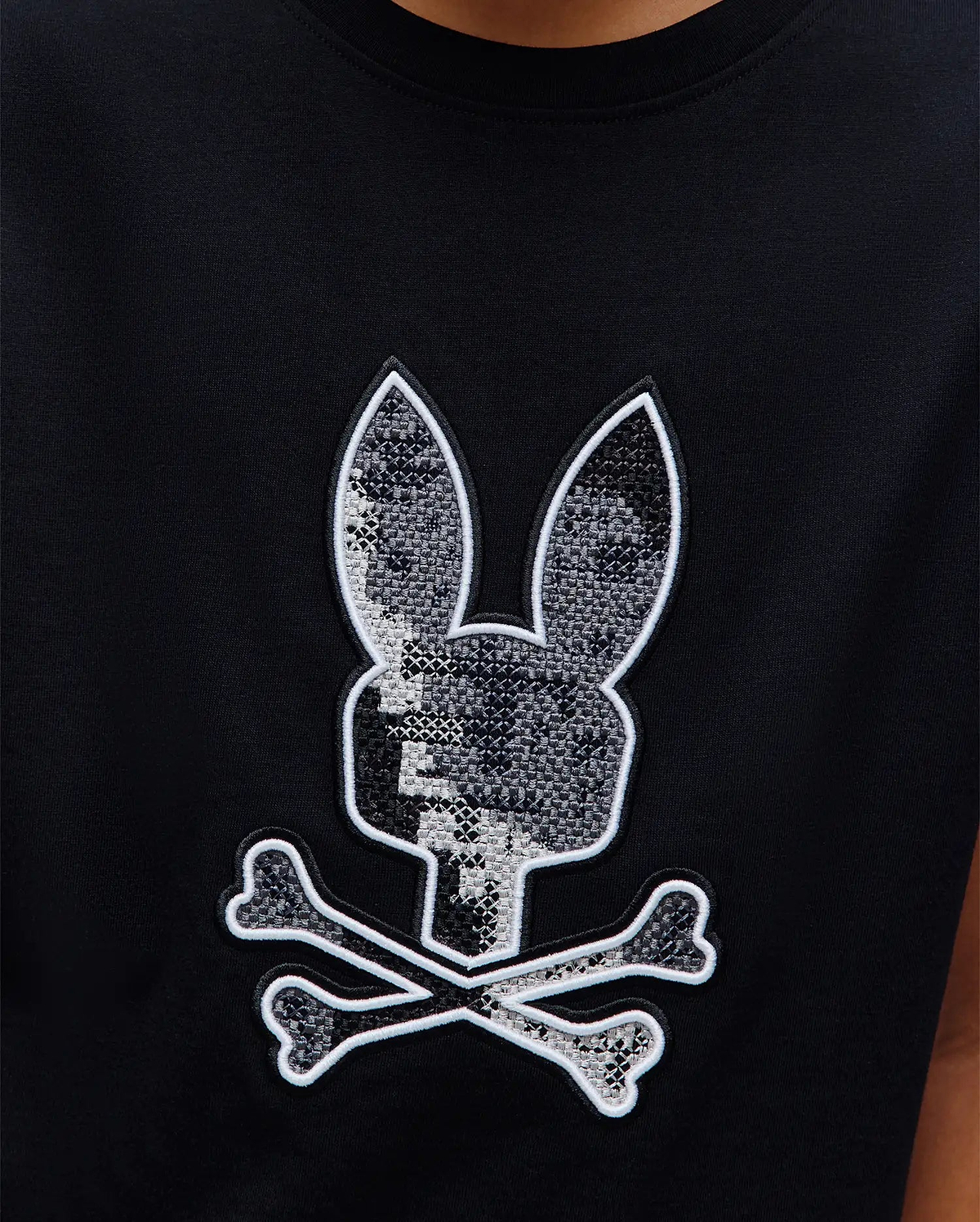 Kids Olivier Graphic Tee, black jersey knit with a large central embroidered Psycho Bunny skull logo featuring a grey pixelated pattern and white outline. (3)