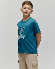 Kids Olivier Graphic Tee, a classic fit teal jersey t-shirt featuring a large chest graphic of the iconic Psycho Bunny skull logo with green and blue camouflage pattern and light blue bones, outlined in white. (2)