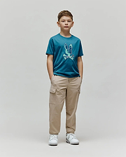 Kids Olivier Graphic Tee in teal jersey, featuring a large, textured blue and green Psycho Bunny skull and crossbones graphic on the chest, paired with relaxed fit khaki cargo pants. (4)