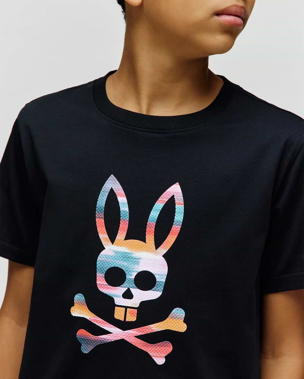 Kids Raphael Graphic Tee, a classic fit black jersey t-shirt with a large, vibrant, textured multi-color Psycho Bunny skull and crossbones graphic on the chest. (3)