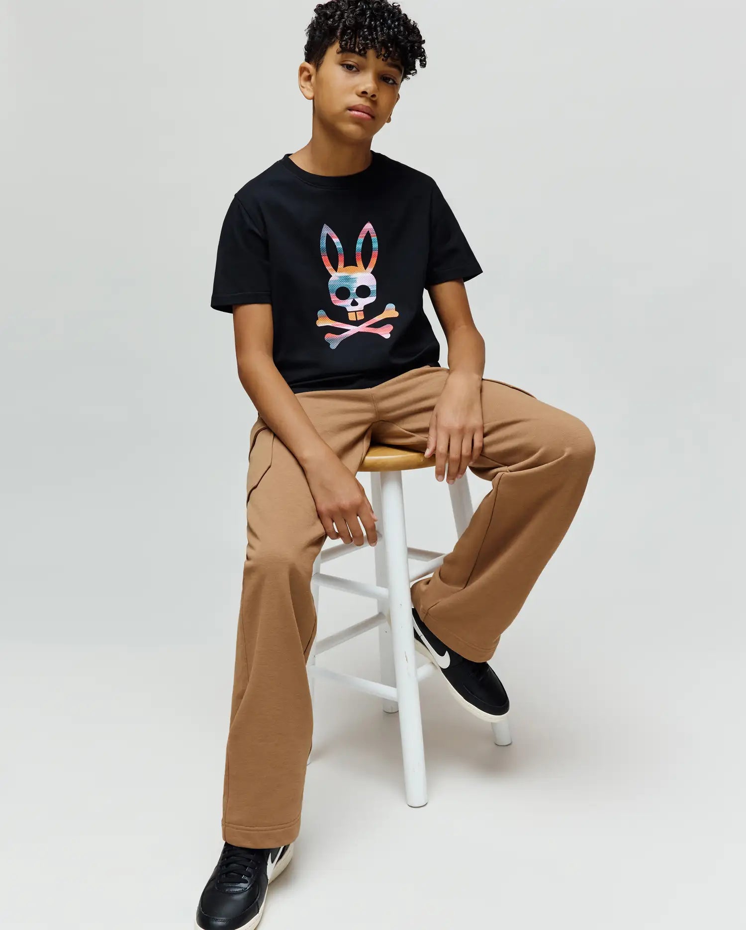 Kids Raphael Graphic Tee in black jersey, featuring a classic fit and a large, vibrant multicolor graphic Psycho Bunny skull and crossbones logo on the center chest. (2)