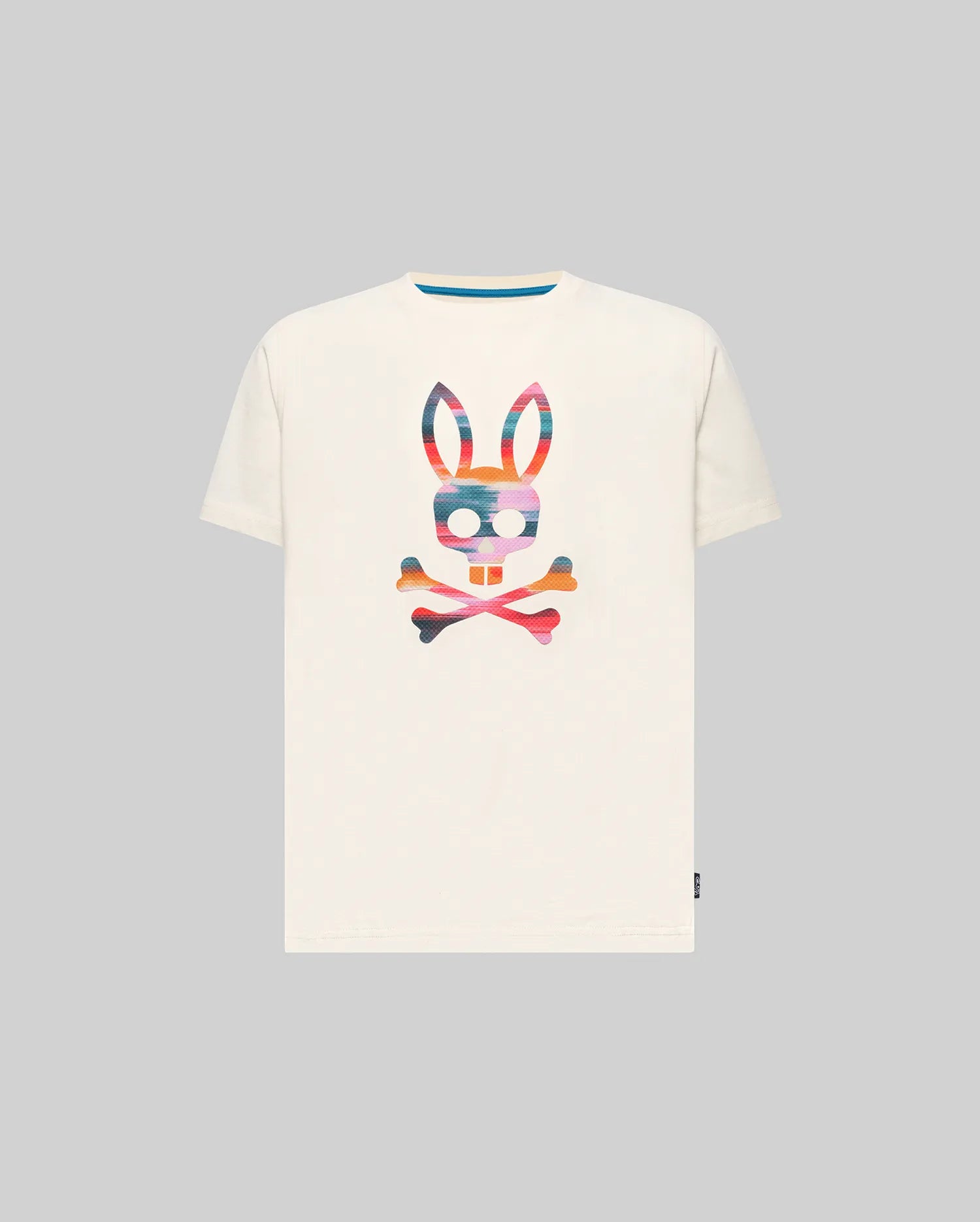 Kids Raphael Graphic Tee, a classic fit off-white jersey t-shirt featuring a large, vibrant multi-color striped Psycho Bunny skull graphic on the chest and a blue inner collar detail.