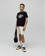 Kids Herman Graphic Tee, a black classic fit cotton jersey t-shirt featuring a large central chest graphic of the Psycho Bunny logo and text in blue and pink distressed print.