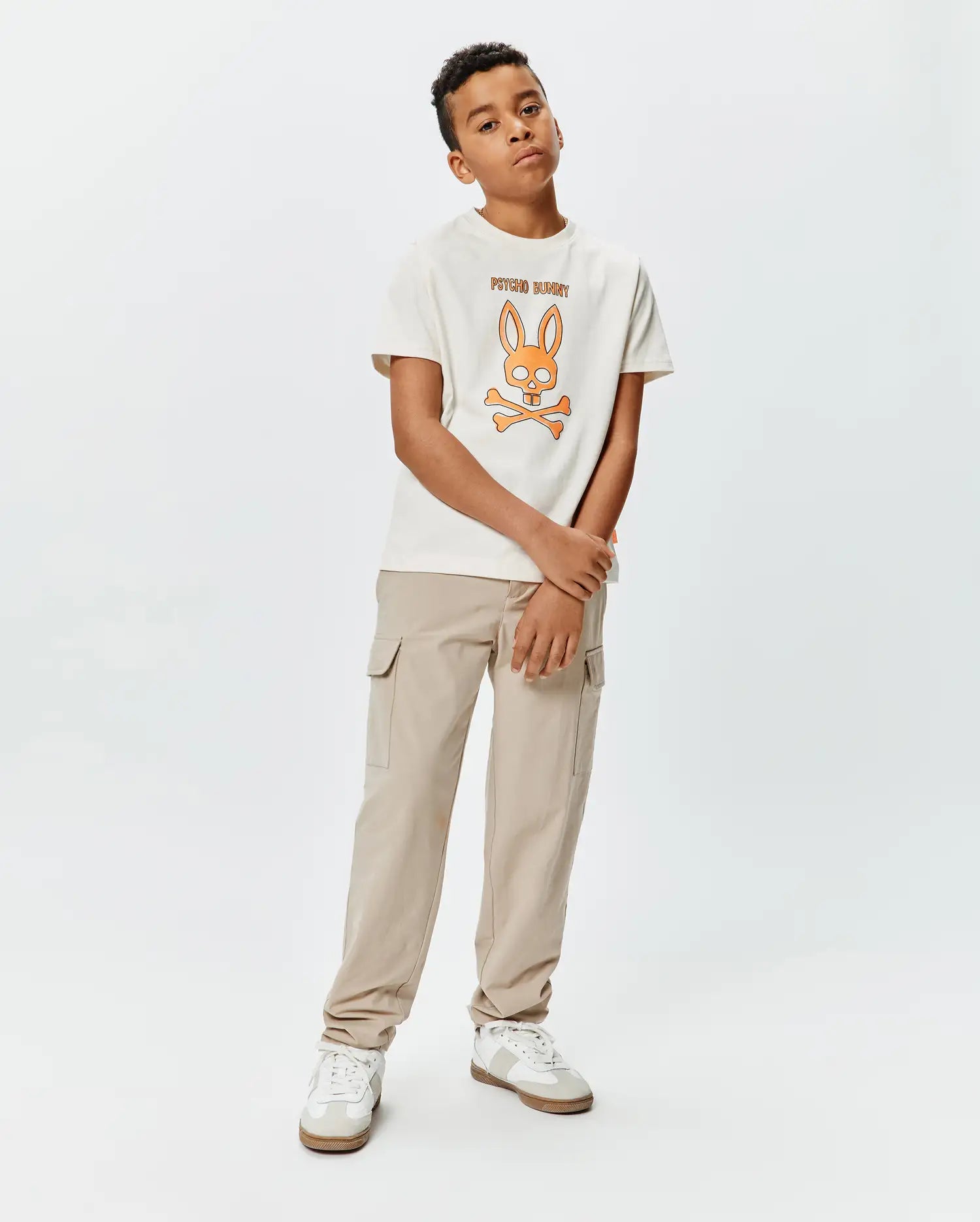 Kids Adler Graphic Tee in cream jersey with a classic fit, featuring a large orange and brown Psycho Bunny skull graphic and brand name on the chest.
