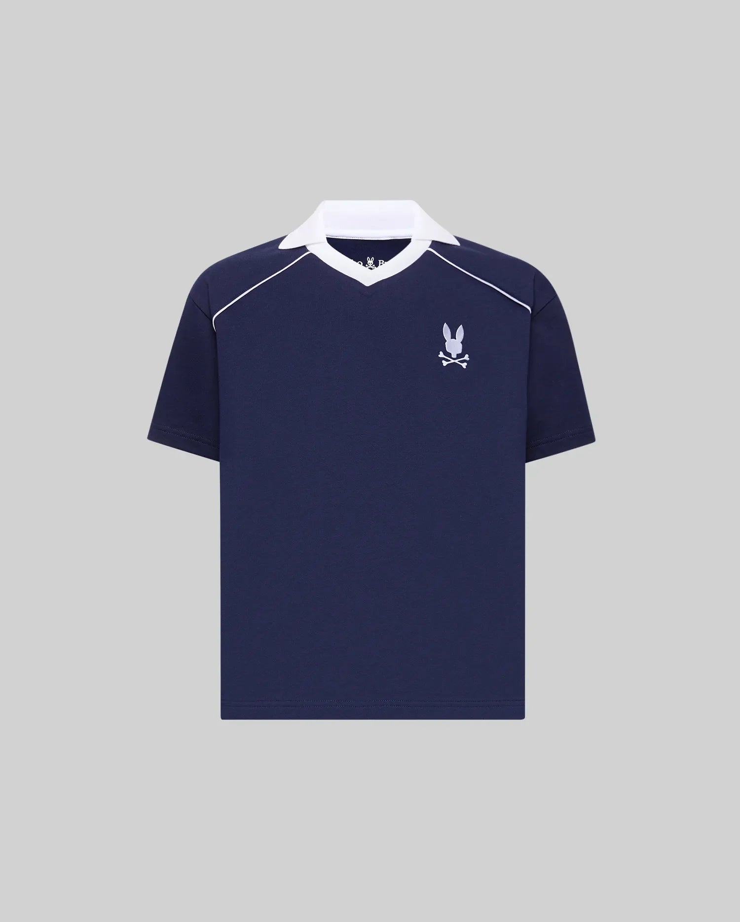 Kids Toby Jersey in navy blue, featuring a white spread collar, white shoulder piping, and an embroidered white Psycho Bunny skull logo on the left chest. Relaxed fit jersey knit.