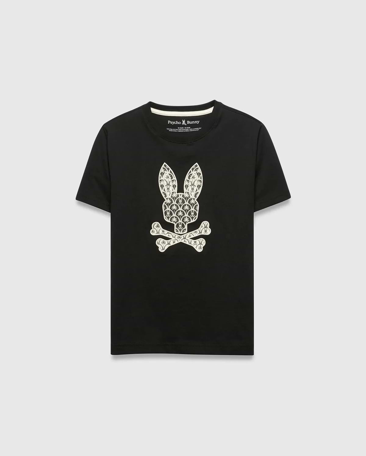 Kids Brad Graphic Tee, black jersey t-shirt with a large white Psycho Bunny skull and crossbones graphic on the chest, featuring a pattern of small bunny logos and palm trees. Classic fit.