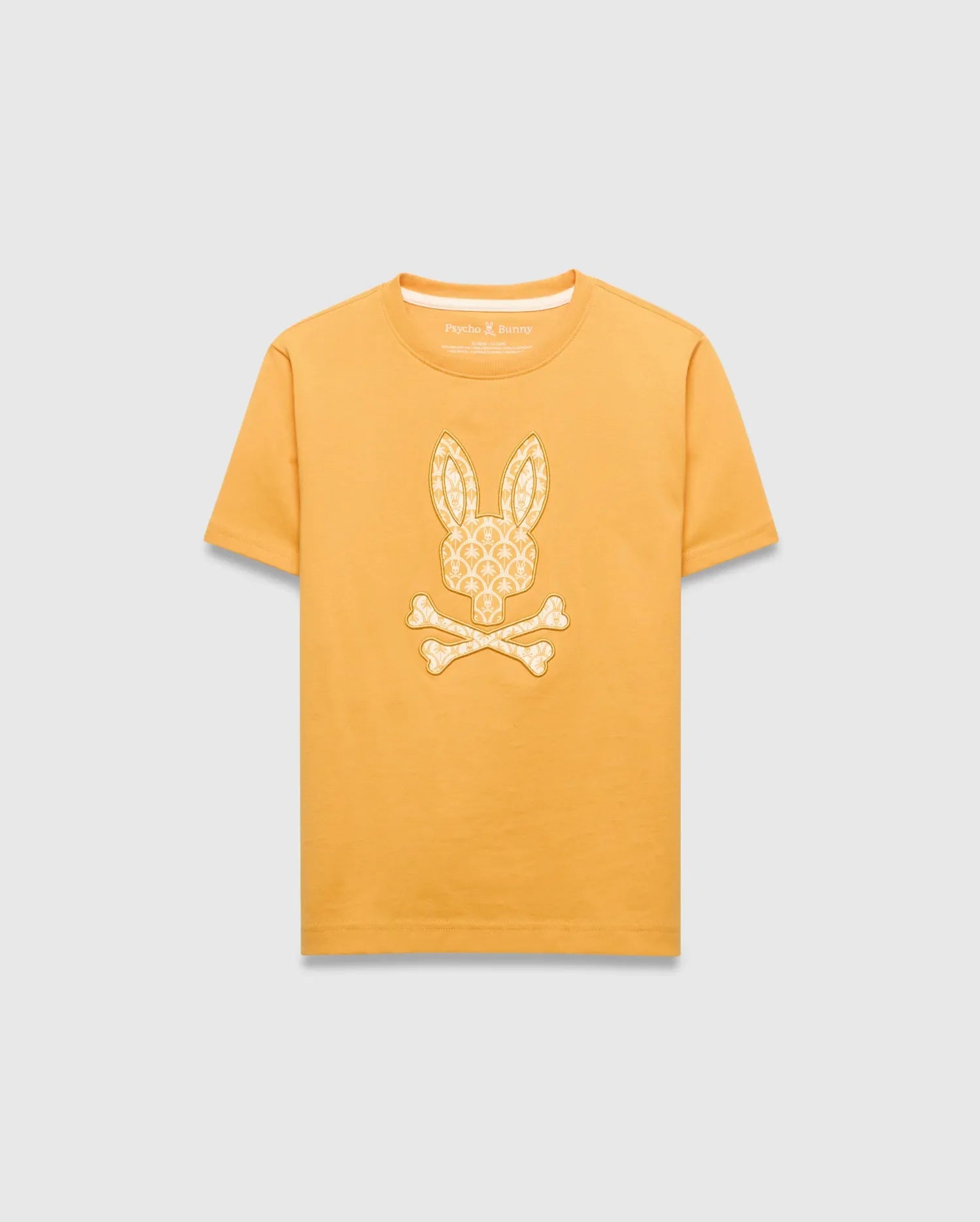 Kids Brad Graphic Tee in golden yellow jersey knit, featuring a large central off-white Psycho Bunny skull logo graphic filled with a subtle repeating bunny pattern, classic fit.