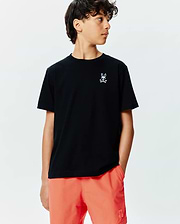 Kids Sunny Chest Graphic Tee, black classic fit jersey t-shirt, small blue/white gradient embroidered Psycho Bunny skull logo on chest. Paired with vibrant orange relaxed fit swim shorts, tonal bunny logo.