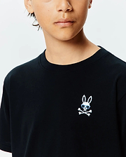 Kids Sunny Chest Graphic Tee, a black classic fit jersey t-shirt featuring a small embroidered white Psycho Bunny skull with light blue sunglasses and crossbones on the left chest.