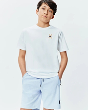 White Kids Sunny Chest Graphic Tee, classic fit jersey, with an embroidered Psycho Bunny sunglasses logo on the chest. Paired with light blue textured shorts featuring a black bunny logo.